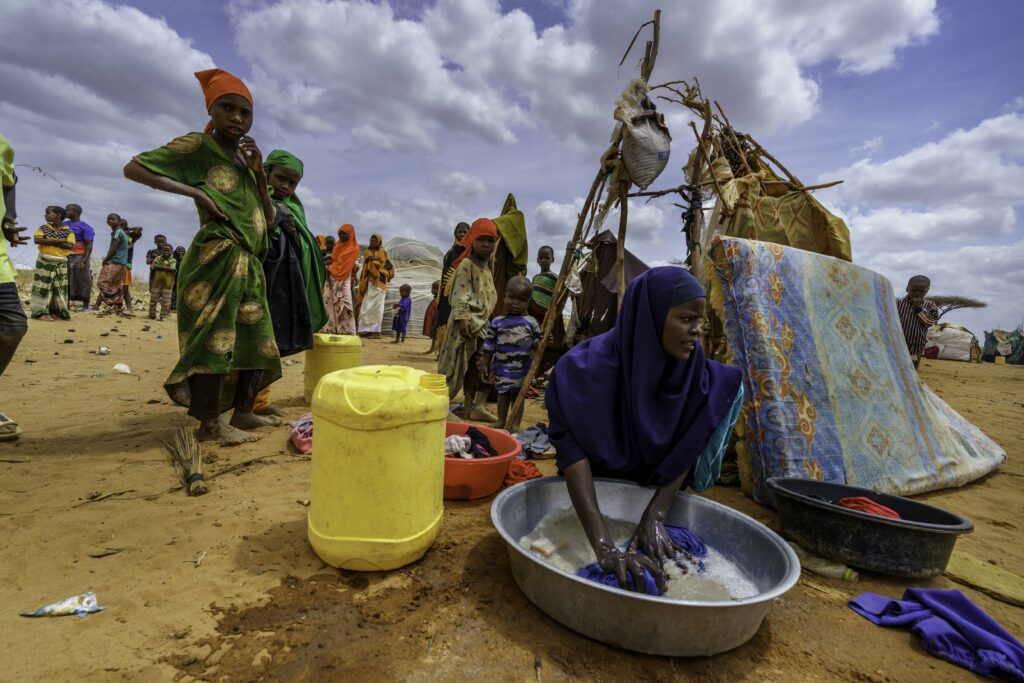 A newly-arrived Somali refugee washes her clothing at a camp near Dadaab, Kenya. Credit: Larry Price