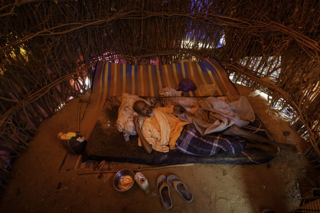 Hassan Hussein, 80, walked into Kenya from Somalia and was too sick to stand up inside a crude hut at a refugee camp outside Dadaab, Kenya. Credit: Larry Price